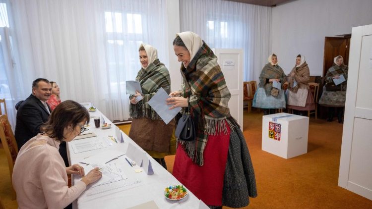 Women in traditional clothing vote at the polling station in Czech Republic
