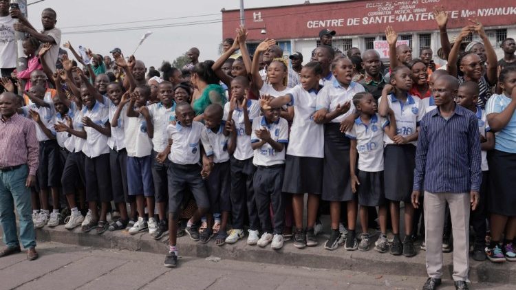 School children in Kinshasa waiting to get a glimpse of Pope Francis.