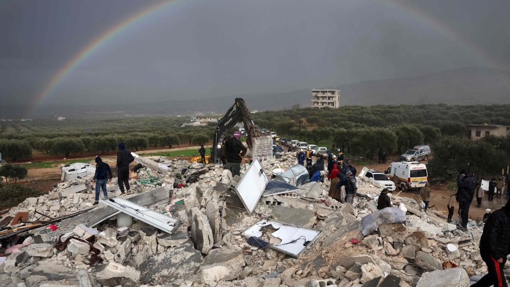 Moradores procuram پ e sobreviventes em meio aos escombros de prdios desabados aps um terremoto na vila de Besnaya, na provncia de Idlib, no noroeste da , controlada por rebeldes, na fronteira com a Turquia. (Foto de OMAR HAJ KADOUR/AFP)