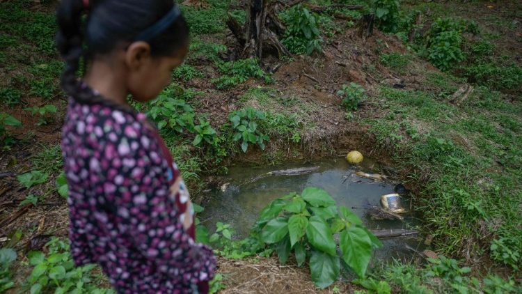 An inhabitant of the Ecuadorian Amazon next to a polluted pond