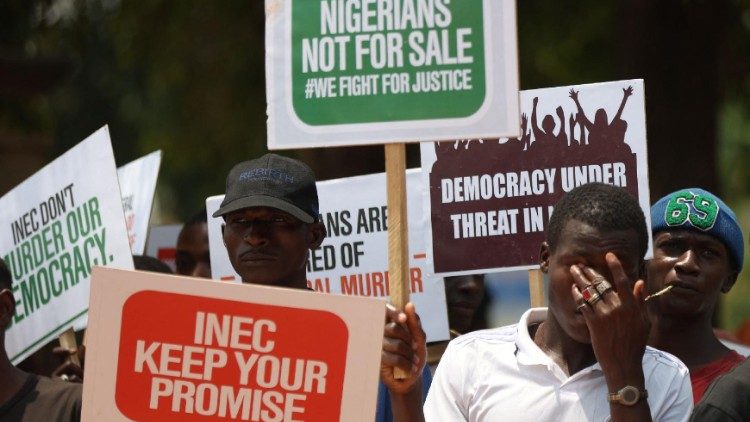 Protesters display placards to protest the outcome of the 2023 presidential election in Nigeria