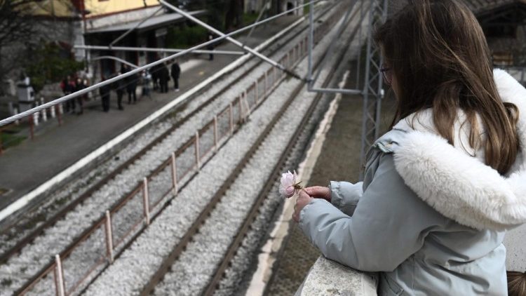 A girl holds a flower at the railway station in Rapsani, northern Greece