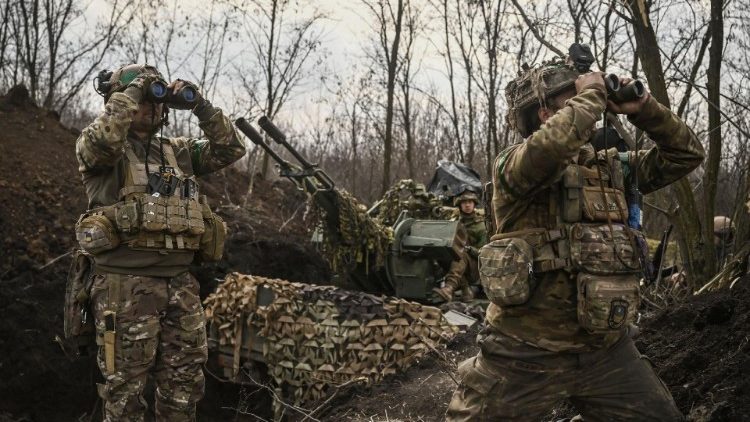 Ukrainian servicemen scan the skies near Bakhmut