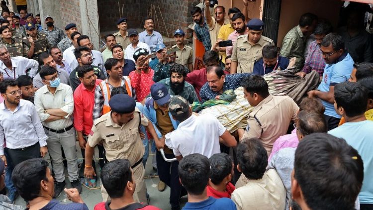 Emergency workers carry a victim out of the temple on a stretcher