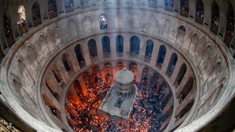 File photo showing Orthodox Christians gathering around the Edicule with lit candles during the Holy Fire ceremony at Jerusalem's Church of the Holy Sepulchre