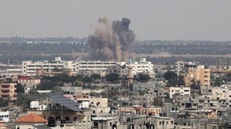 Smoke rises above buildings east of Rafah, in the southern Gaza Strip, during an Israeli strike