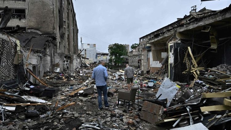Residents of Kramatorsk, Ukraine, walk among debris from a Russian missile strike