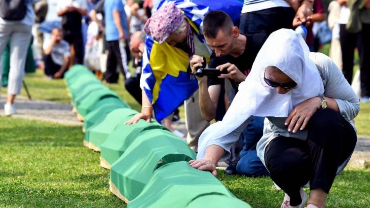  A Bosnian Muslim woman, survivor of the Srebrenica 1995 massacre mourns near the casket containing the remains of a relative and victim of the Srebrenica 1995