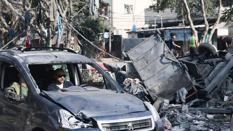 A man drives a damaged car through a street ravaged by Israeli bombing in Rafah in the southern Gaza Strip on November 2, 2023, as battles between Israel and the Palestinian Hamas movement continue