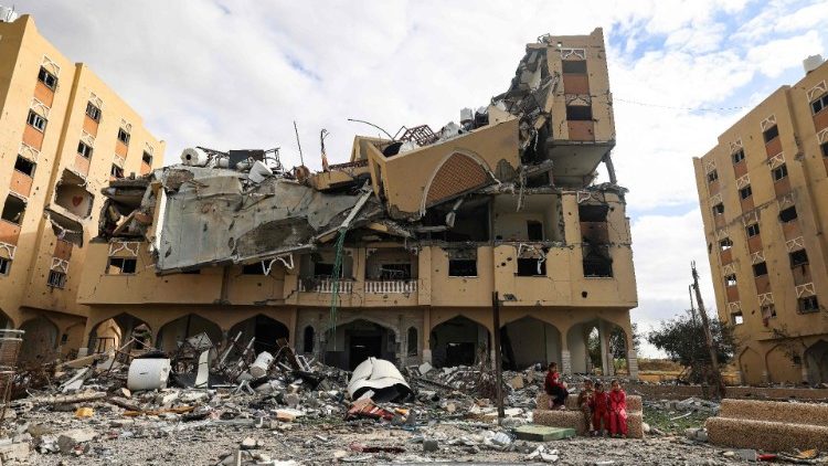 Palestinians inspect the destruction of a building in Wadi Gaza