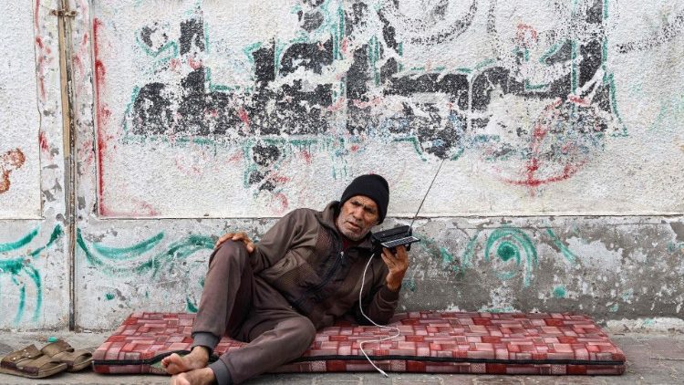 A Palestinian listens to his radio in a refugee camp in Rafah, southern Gaza