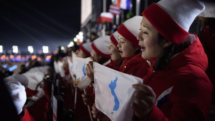 Derrière le drapeau bleu et blanc de l’unification coréenne, 22 sportifs nord-coréens ont défilé avec leurs homologues du Sud à Pyeongchang, le 9 février 2018.