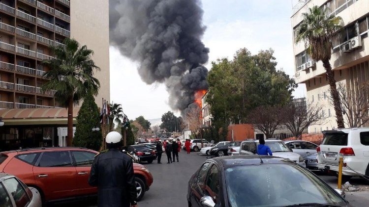 Flames and smoke rise after a mortar shell exploded near to the old Damascus fairground