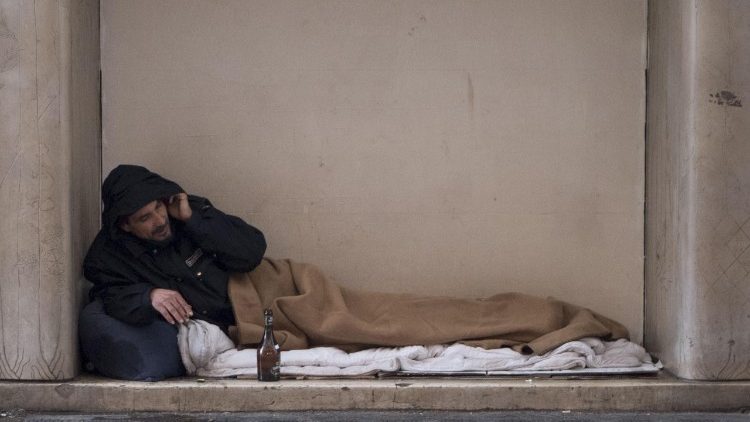 A homeless man sleeps outside in Rome during freezing weather