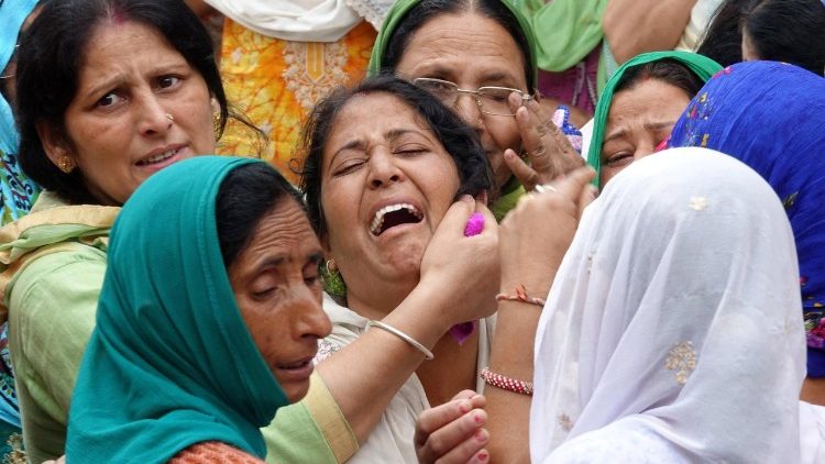 Relatives of the victims of the school bus accident in India's Himachal Pradesh mourn their dead 