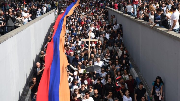 Armenians carry a giant flag at a commemorative march in Yerevan, Armenia