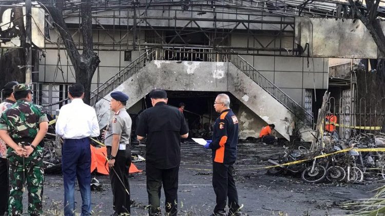 Officials inspect an Indonesian church after it was bombed on Sunday morning