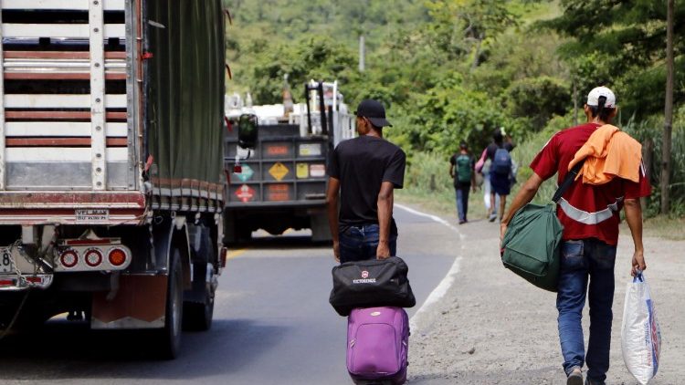 Venezuelan citizens walk on the Curcuta - Pamplona road in Colombia after fleeing hardship in their country 