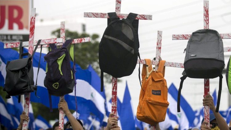 Jovens carregam cruzes com mochilas em memória aos estudantes mortos nos protestos