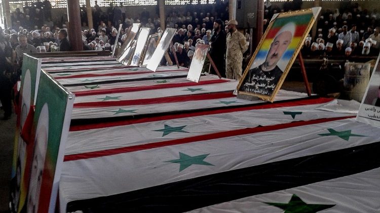 Druze clerics and citizens attend a funeral ceremony for victims of the attacks that targeted the al-Sweida province in Southern Syria