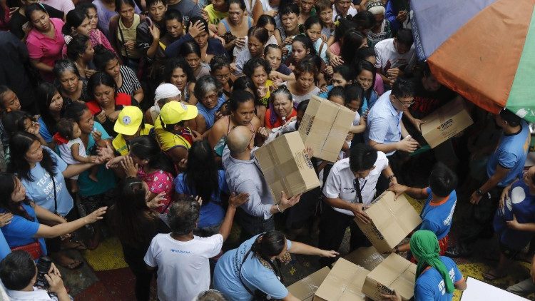 Relief material being distributed to flood-affected people in the Philippine capital, Manila. 