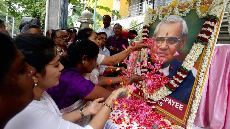Indians paying homage to a portrait of late Atal Bihari Vajpayee.