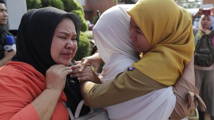 Relatives of victims of Indonesia's plane crash mourning their loved ones.