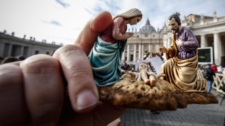 A member of the faithful holds a statuette of the Holy Family at Pope Francis' Angelus address on Sunday
