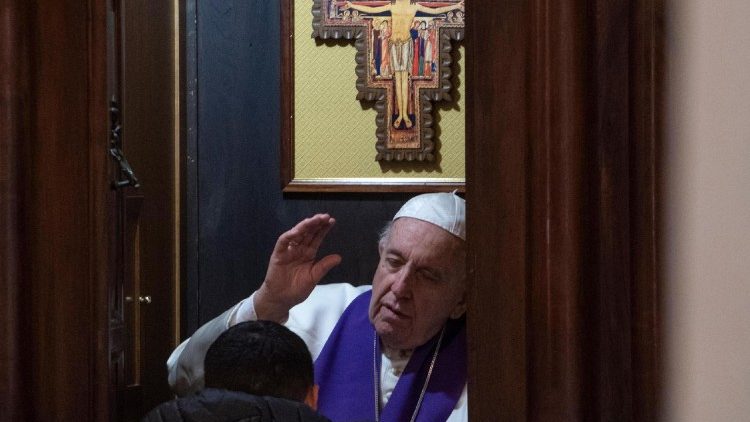 Pope Francis hears a priest's confession