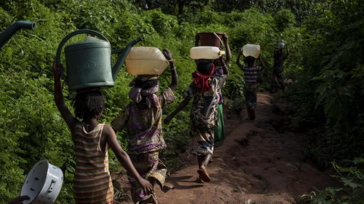 Mujeres transportan agua hacia sus hogares