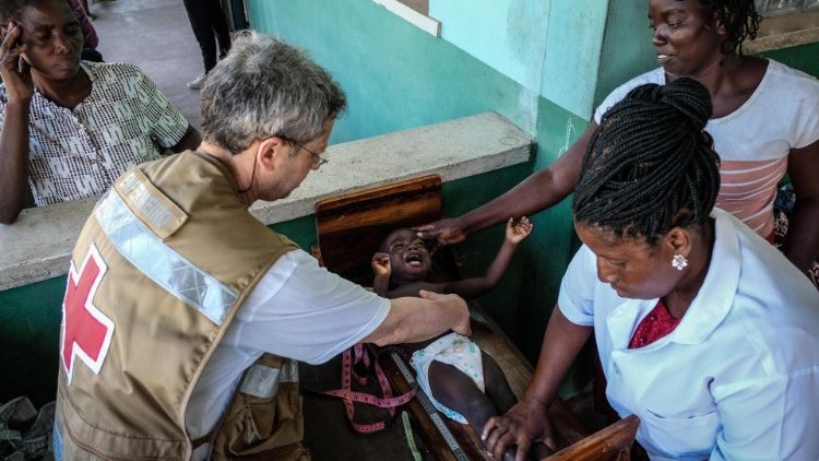 A Red Cross worker assists people at a hospital in Mozambique (file photo)