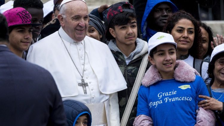 Pope Francis poses at a General Audience with migrants recently-arrived from Libya