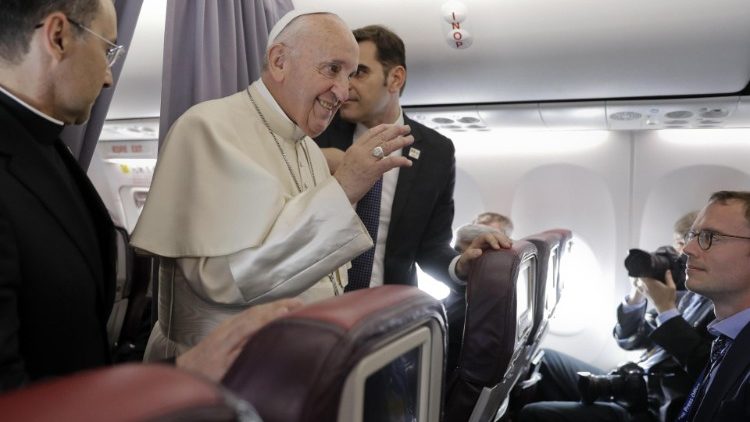 Pope Francis answers questions during the inflight press conference as he returns from Romania