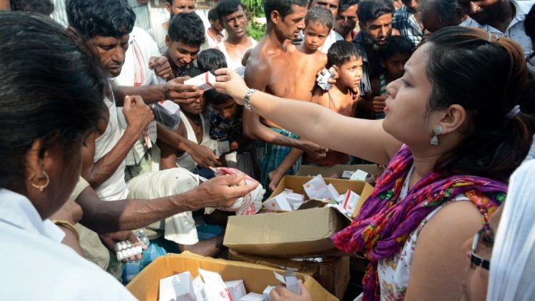 Health workers distributing medicines to flood affected people in Assam, India.