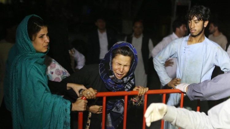 An Afghan woman grieves over the loss of her husband and 2 sons