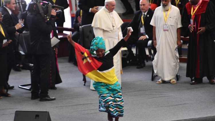 A young girl dances for Pope Francis during the interreligious meeting with the youth