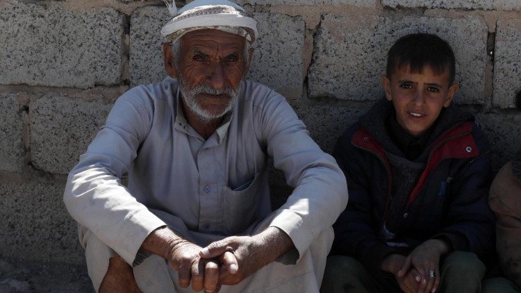 In Sanaa, Jemen, warten ein Großvater und sein Enkelsohn auf ihre Essensration - immer mehr Menschen sind auf Lebensmittelversorgung von Hilfsorganisationen angewiesen