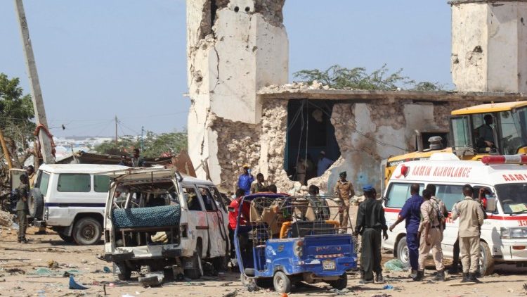 Security officers gather at the scene of a large explosion in Mogadishu