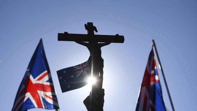 Australian flags seen waving around a crucifix