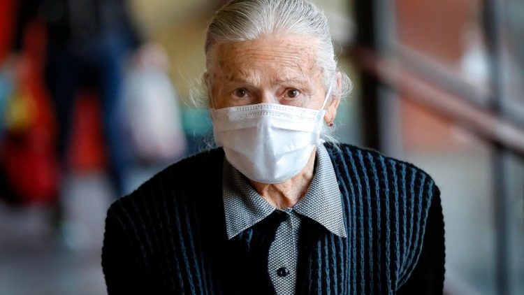 Seniorin aus Rumänien mit Atemschutzmaske