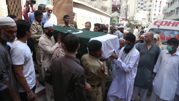 Mourners carry a victim's coffin after the PIA crash in Karachi