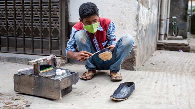 A shoeshine in Dhaka, Bangladesh, plying his trade amid the Covid-19 emergency