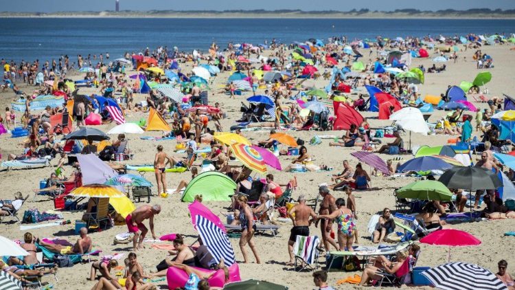 Sunbathers crowd a beach near Brouwersdam in The Netherlands