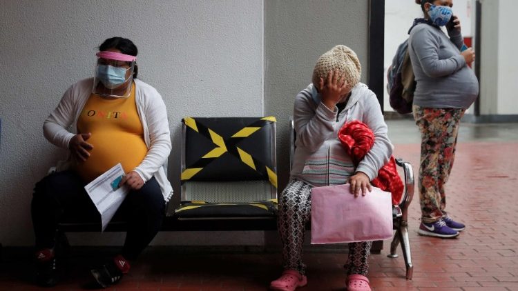 Three pregnant women await treatment at a hospital in Lima, Peru