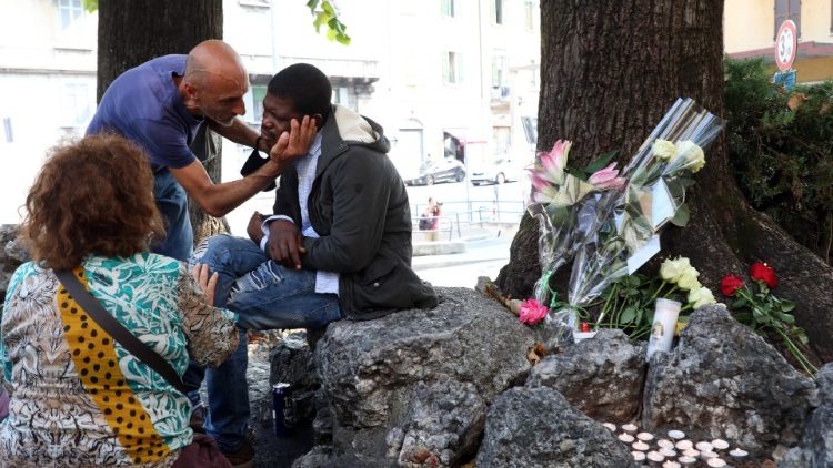 Des paroissiens réconfortent un migrant bouleversé par la mort du père Malgesini, le 15 septembre 2020 à Côme.