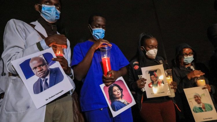Protesting Kenyan doctors hold photos of deceased colleagues who died of Covid-19
