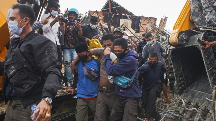 Rescuers evacuate a survivor in Mamuju, West Sulawesi
