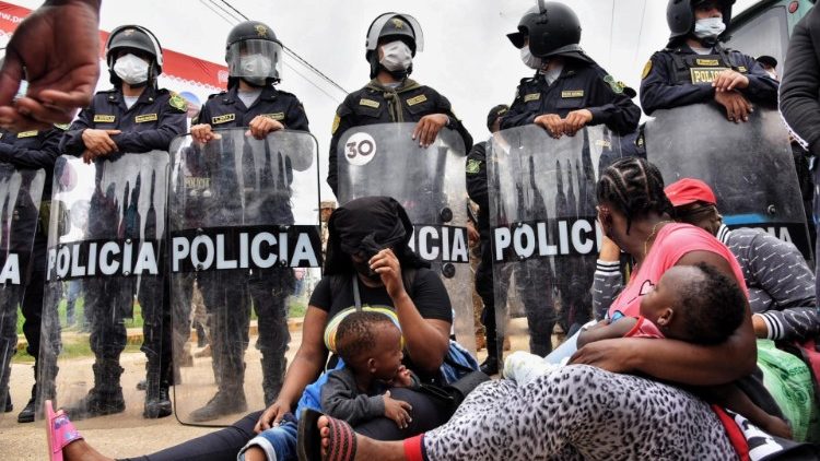 Un grupo de personas intenta atravesar un bloqueo policial tras cruzar la frontera de Brasil a Perú, en la localidad de Iñapari, Madre de Dios, Perú, 16 de febrero de 2021.