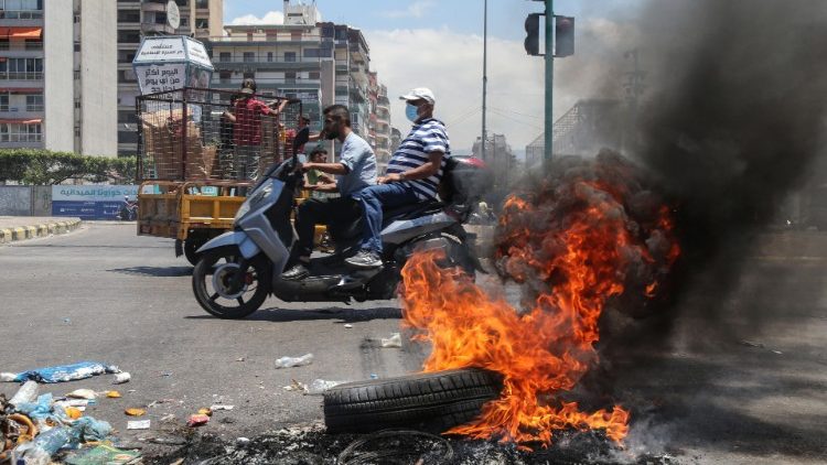 Tyres burn at a makeshift roadblock in Beirut on 17 June
