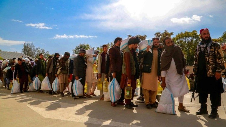 Displaced Afghans receive food aid in the capital Kabul